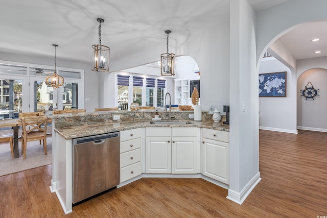 kitchen with sink, white cabinetry, decorative light fixtures, dishwasher, and kitchen peninsula