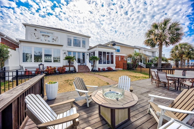 wooden deck with a yard and a sunroom