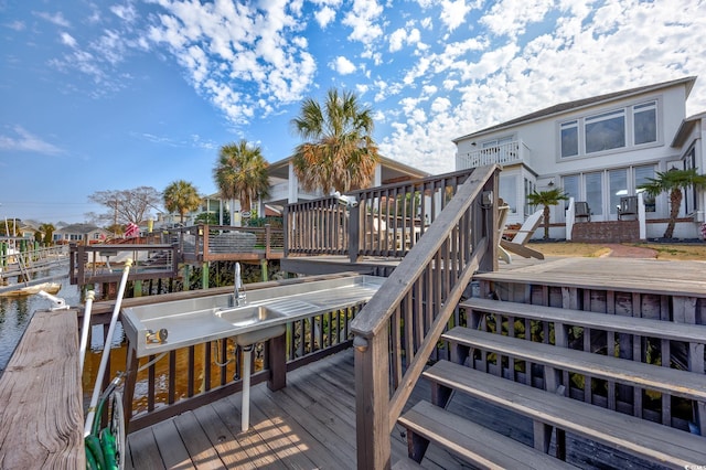 wooden terrace featuring a water view