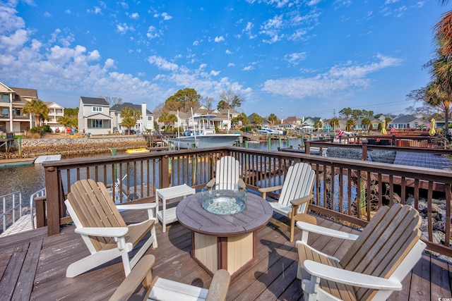 deck with a fire pit and a water view