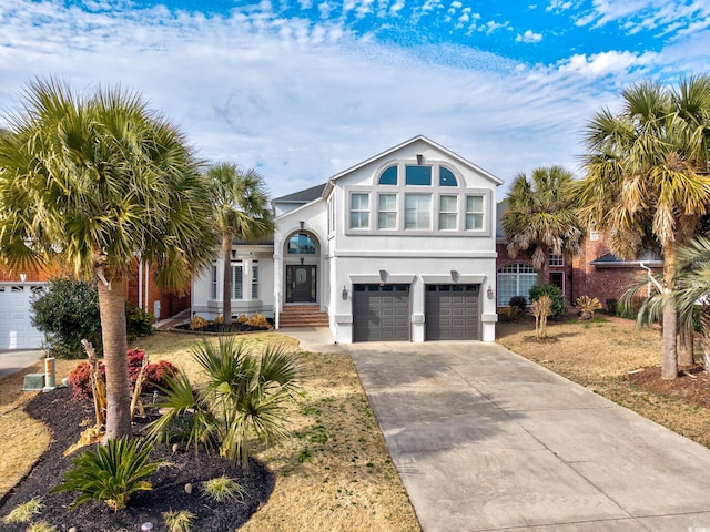 view of front of property with a garage and a front yard