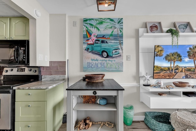 kitchen featuring tasteful backsplash, green cabinetry, and stainless steel electric range oven