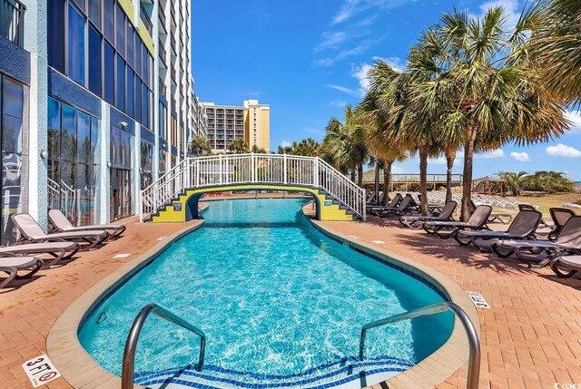 view of swimming pool featuring a patio area