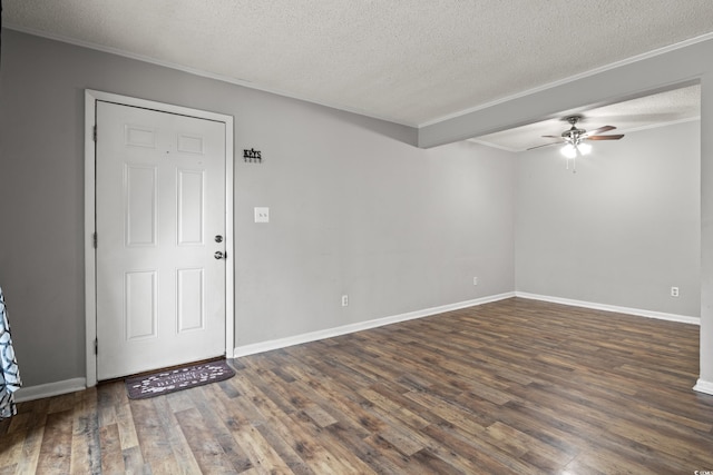 spare room with ornamental molding, dark hardwood / wood-style floors, ceiling fan, and a textured ceiling