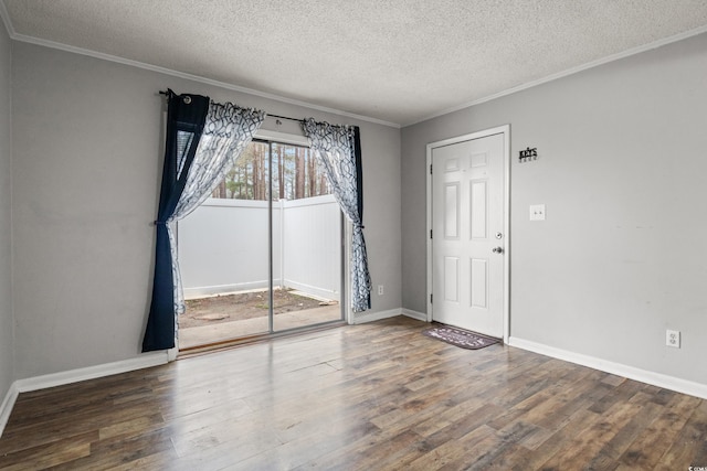 unfurnished room with dark hardwood / wood-style flooring, ornamental molding, and a textured ceiling