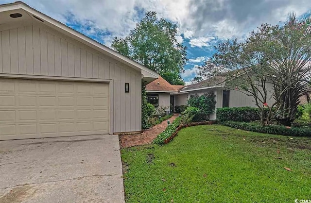 ranch-style home with a garage and a front yard