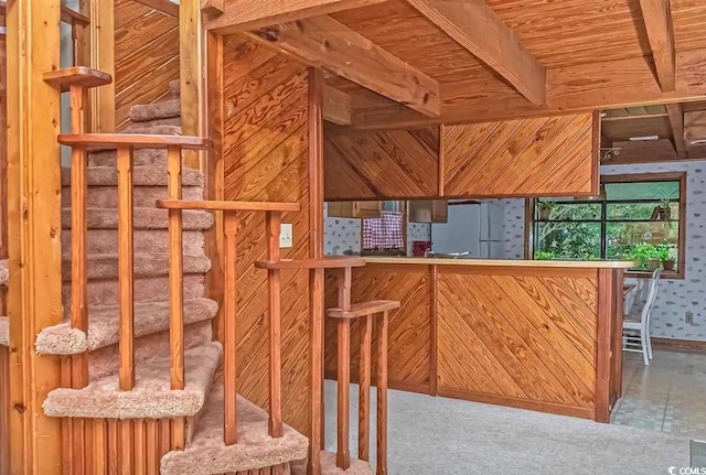 interior space with white refrigerator, wood ceiling, and beamed ceiling