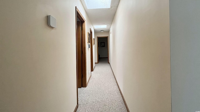 hall featuring light carpet