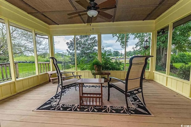 sunroom / solarium featuring ceiling fan