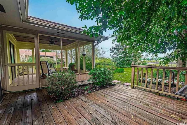 deck featuring a sunroom and ceiling fan