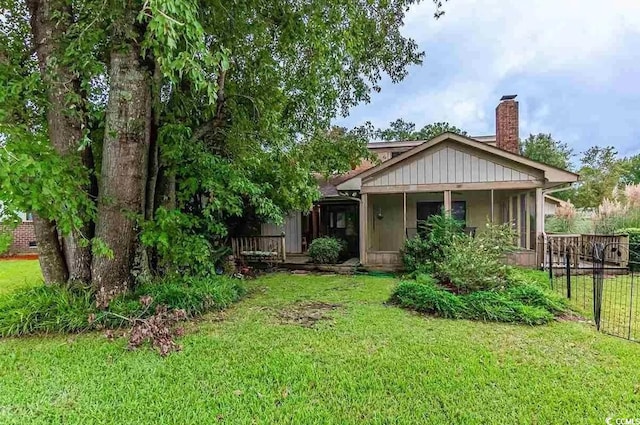 rear view of house with a lawn