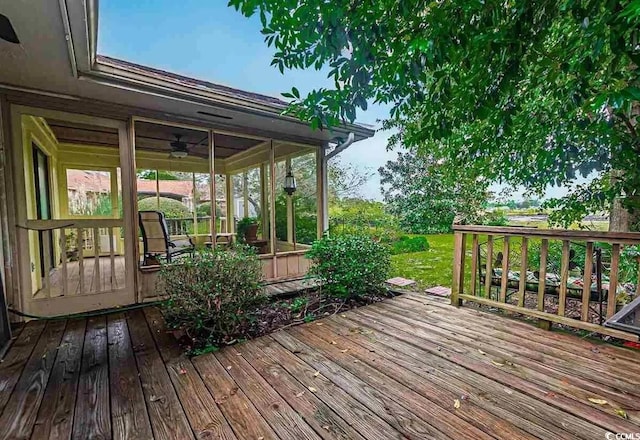 wooden deck with a sunroom