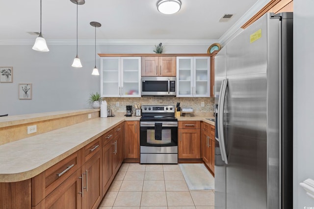 kitchen featuring pendant lighting, light tile patterned floors, stainless steel appliances, decorative backsplash, and kitchen peninsula