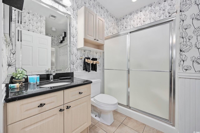 bathroom featuring tile patterned floors, toilet, an enclosed shower, and vanity