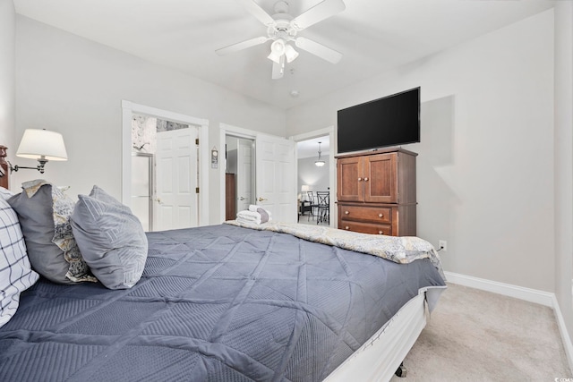 bedroom with ceiling fan, light colored carpet, and a closet