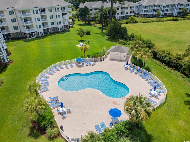 view of swimming pool featuring a yard and a patio area