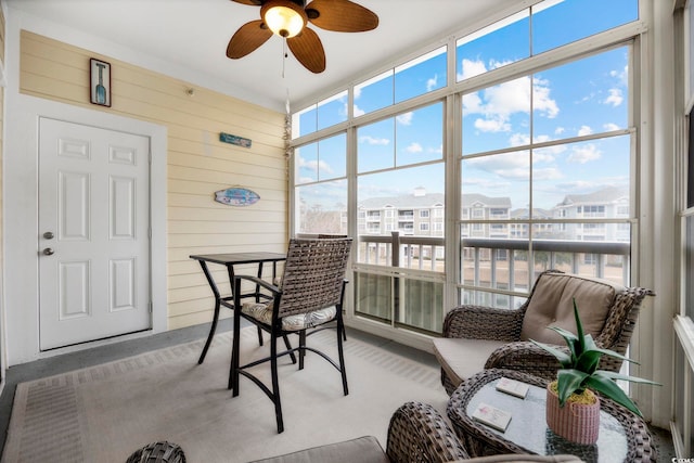 sunroom / solarium featuring a wealth of natural light and ceiling fan