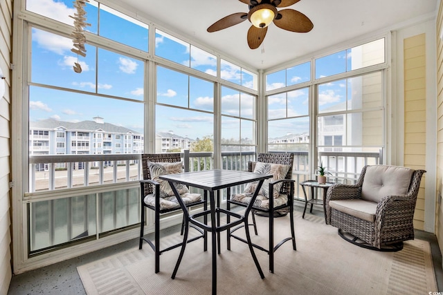 sunroom featuring ceiling fan