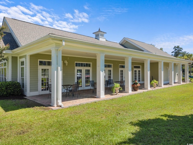 back of house with a patio, a yard, and french doors