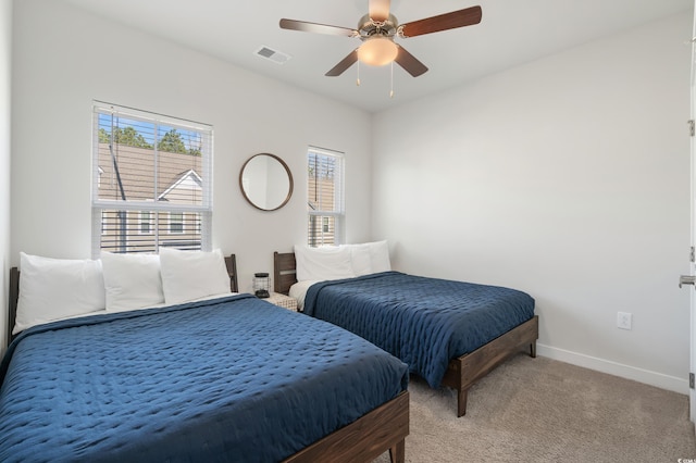 bedroom featuring light colored carpet and ceiling fan