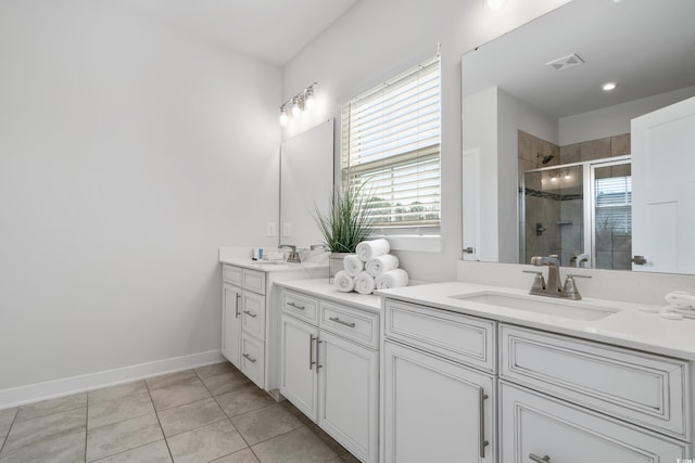 bathroom featuring vanity, tile patterned flooring, and a shower with door