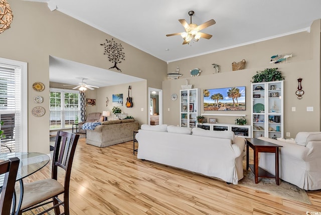 living room featuring crown molding, high vaulted ceiling, ceiling fan, and light hardwood / wood-style floors