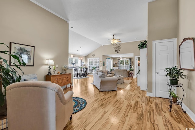 living room featuring ceiling fan, high vaulted ceiling, ornamental molding, and light hardwood / wood-style floors