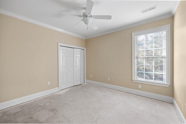 unfurnished bedroom featuring crown molding, ceiling fan, and a closet