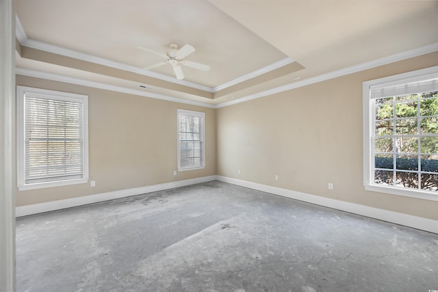 spare room with ceiling fan, ornamental molding, and a raised ceiling