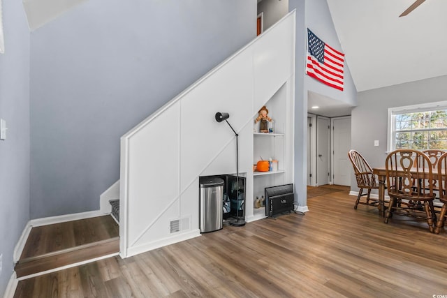 interior space with hardwood / wood-style flooring and high vaulted ceiling