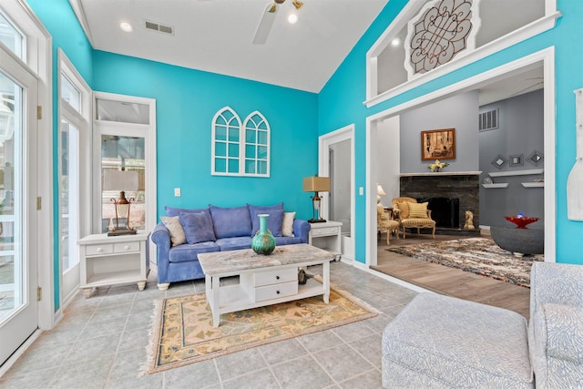 living room with light tile patterned flooring, high vaulted ceiling, and ceiling fan