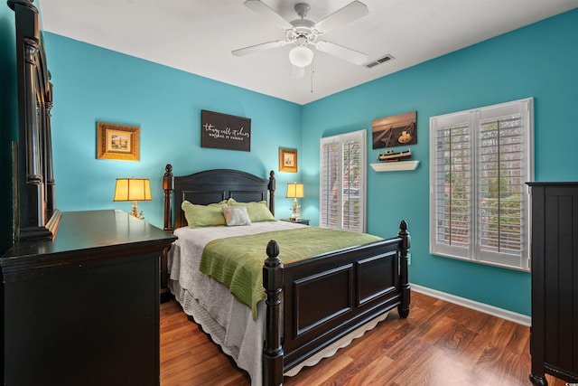 bedroom with dark hardwood / wood-style floors and ceiling fan