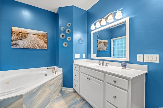 bathroom with tiled tub and vanity