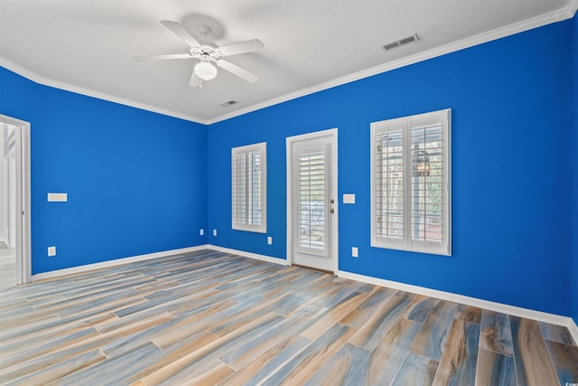 empty room featuring ceiling fan, ornamental molding, and light wood-type flooring