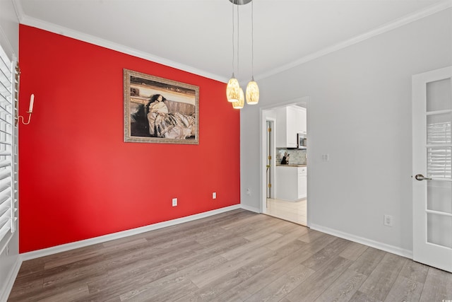 unfurnished room featuring hardwood / wood-style flooring and ornamental molding