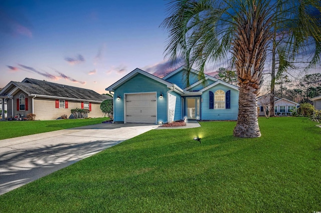 view of front of house with a yard and a garage