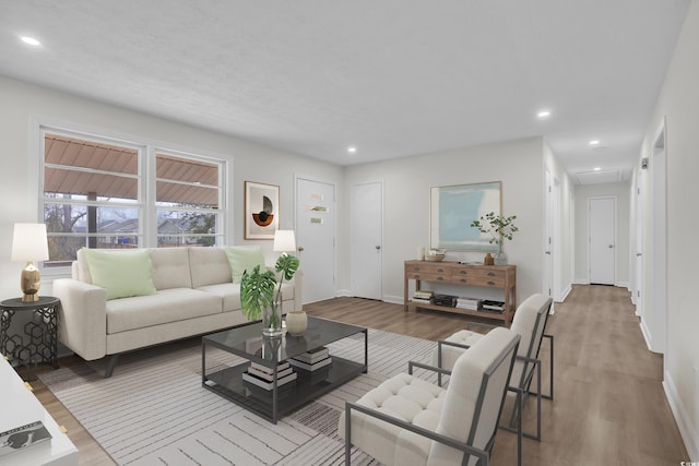 unfurnished living room with visible vents, baseboards, wood finished floors, recessed lighting, and attic access