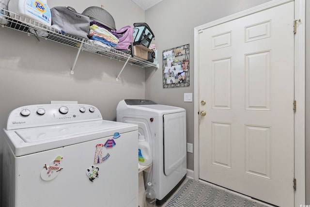 laundry area with washing machine and clothes dryer