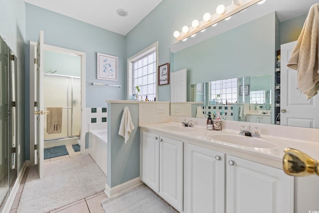 bathroom featuring vanity, shower with separate bathtub, and tile patterned flooring