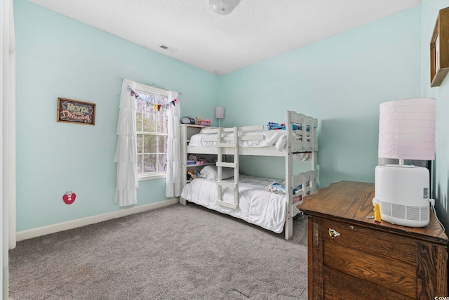 bedroom with carpet flooring and a textured ceiling