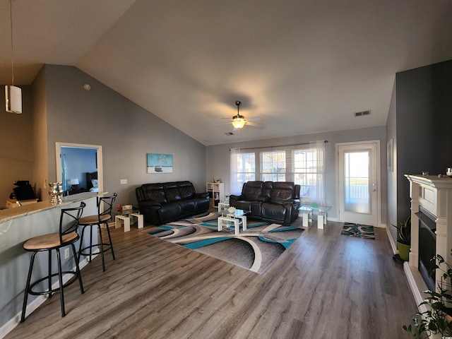 living room featuring hardwood / wood-style flooring, high vaulted ceiling, and ceiling fan