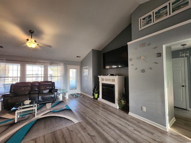 living room with hardwood / wood-style flooring, ceiling fan, high vaulted ceiling, and a wealth of natural light