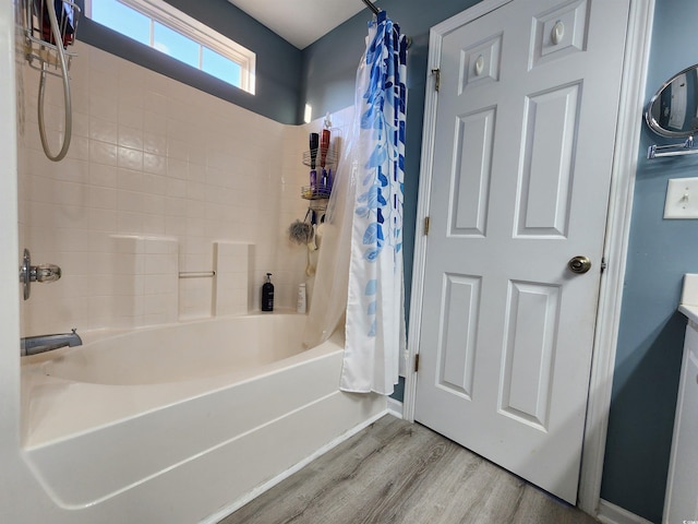 bathroom with hardwood / wood-style flooring and shower / tub combo