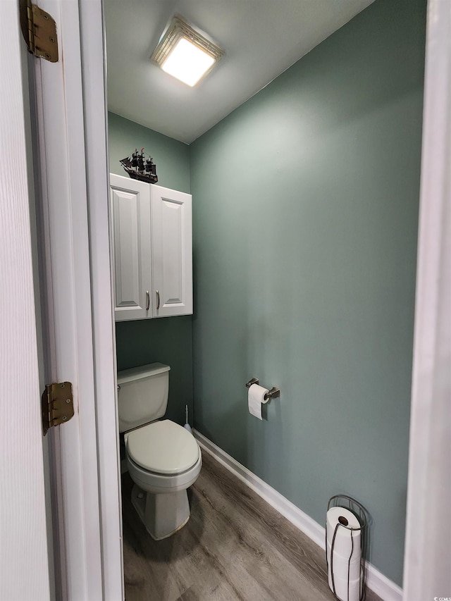 bathroom with wood-type flooring and toilet