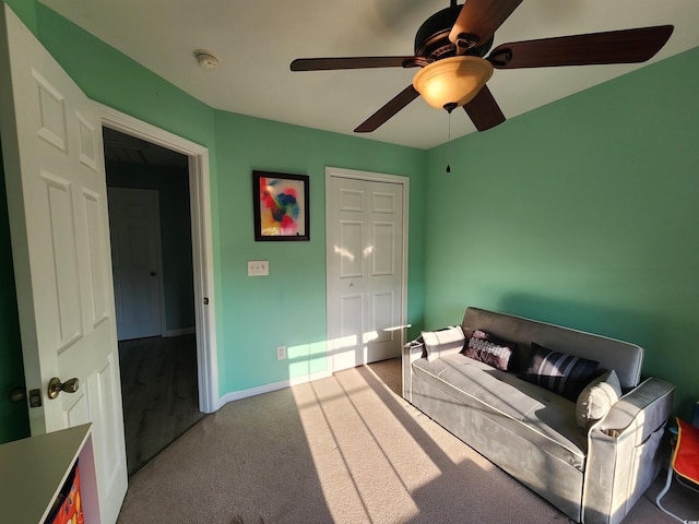 bedroom with ceiling fan, light colored carpet, and a closet