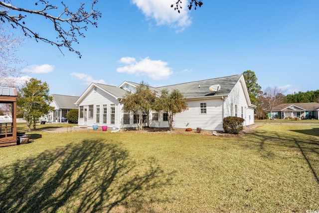 rear view of property with a yard