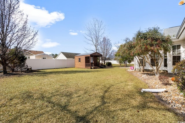 view of yard with a fenced backyard and an outdoor structure