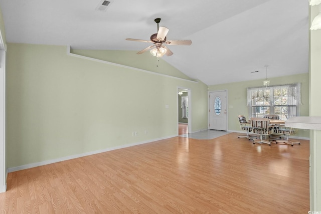 unfurnished living room featuring vaulted ceiling, wood finished floors, visible vents, and baseboards