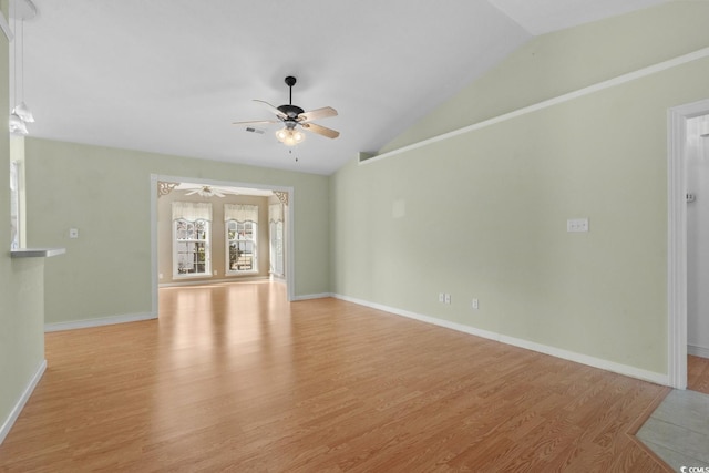 unfurnished living room with visible vents, baseboards, a ceiling fan, lofted ceiling, and light wood-type flooring