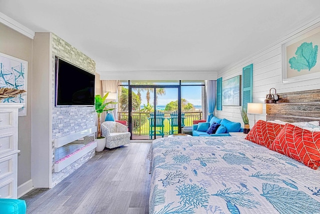 bedroom with wood-type flooring and access to exterior